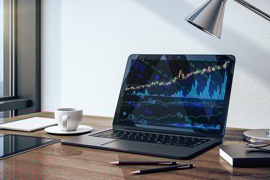 Online trading software with AI on laptop