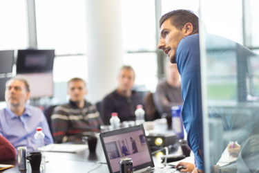 Business people discussing financial statistics