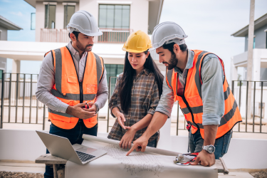 Construction workers on laptop