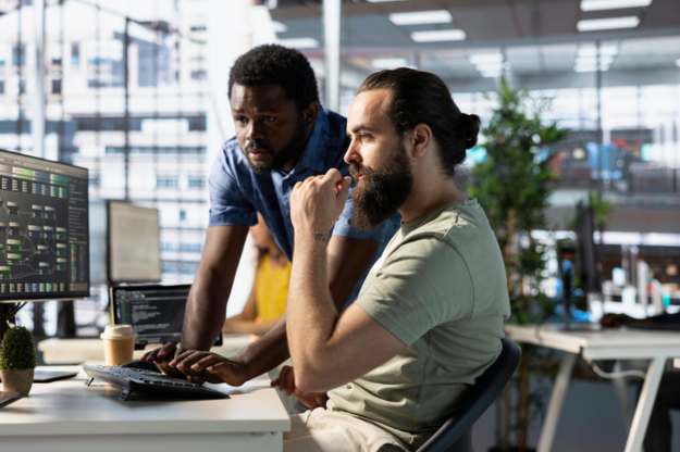 IT workers looking at computer