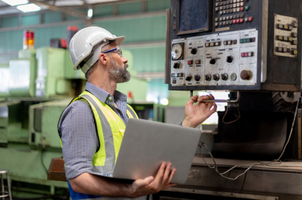 Man engineer with laptop inspecting
