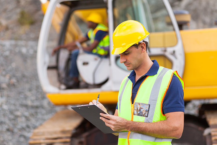Construction worker making notes