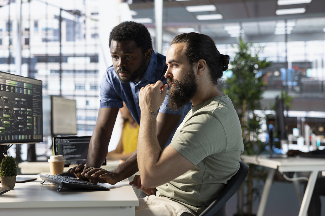 IT team workers looking at computer together