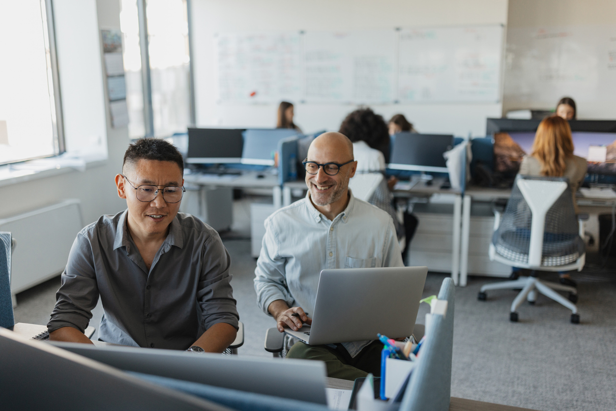 IT team coworkers looking at computer together